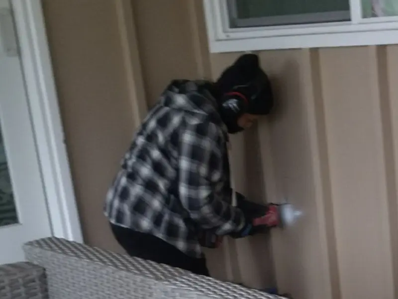 Professional electrician installing an exterior outlet in Half Moon